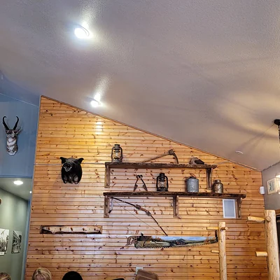 Antler mounts and antique tools on the pine wall at Casa Sanchez Bailey