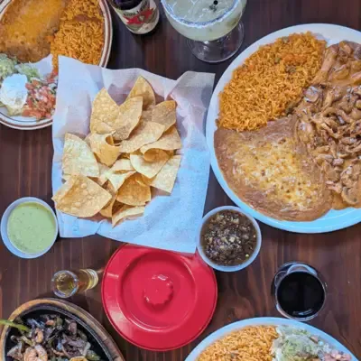 Table spread of chips, salsa, and combination plates